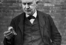 Edison holding a light bulb