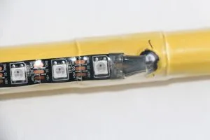 We did our initial build on a yellow colored conduit. This is the end where the power injection ties into the far end of the ribbon. Note the two wires: positive (+5V) and negative (GND).